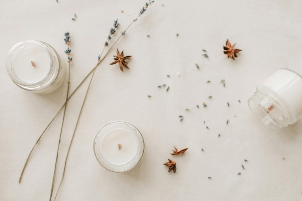 Stylish arrangement of handmade candles with lavender and star anise for a serene ambiance.